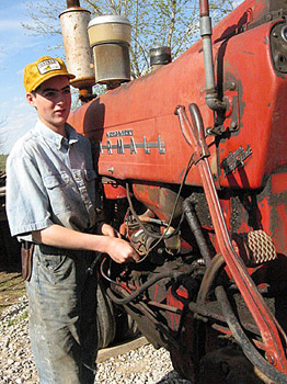 Daniel tuning up Uncle Russ' Farmall 400