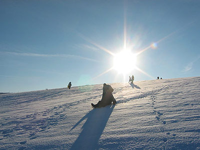 Sledding on the snow-covered field, December 2005